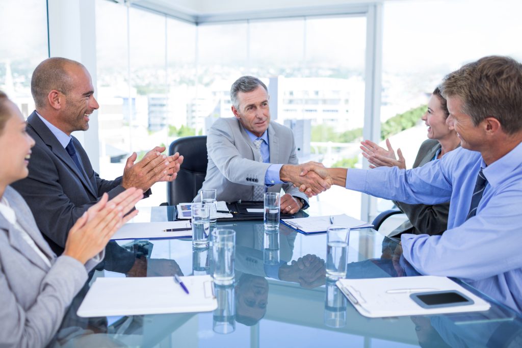 Business boardroom meeting shaking hands image